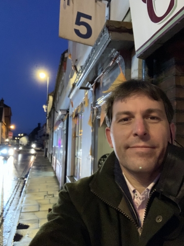 Photograph of John outside shops on Small Business Saturday